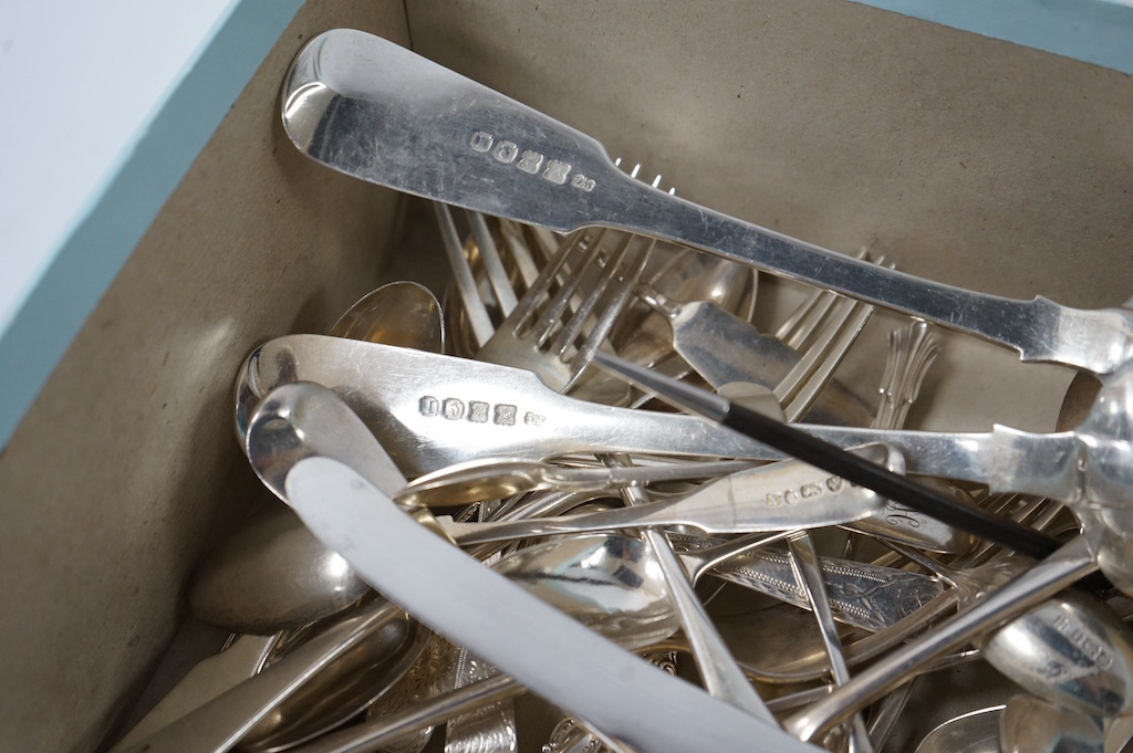 A quantity of assorted mainly 19th century silver flatware, various date, makers and patterns including a pair of George IV silver fiddle pattern table spoons, by William Cummins, Dublin, 1829, 33oz. Condition - poor to